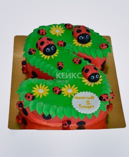Яркий торт с божьими коровками на лужайке Яркий торт с божьими коровками на лужайке Фото