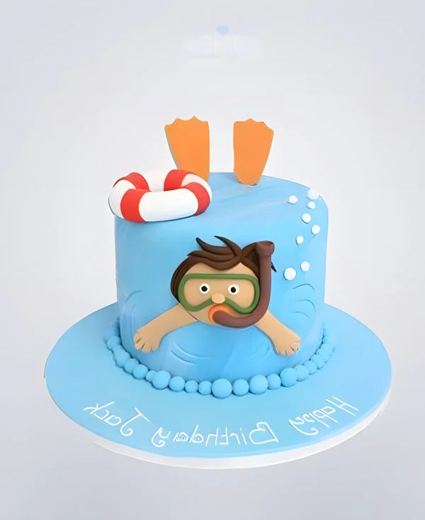 Синий торт плавание с человеком в маске Синий торт плавание с человеком в маске Фото