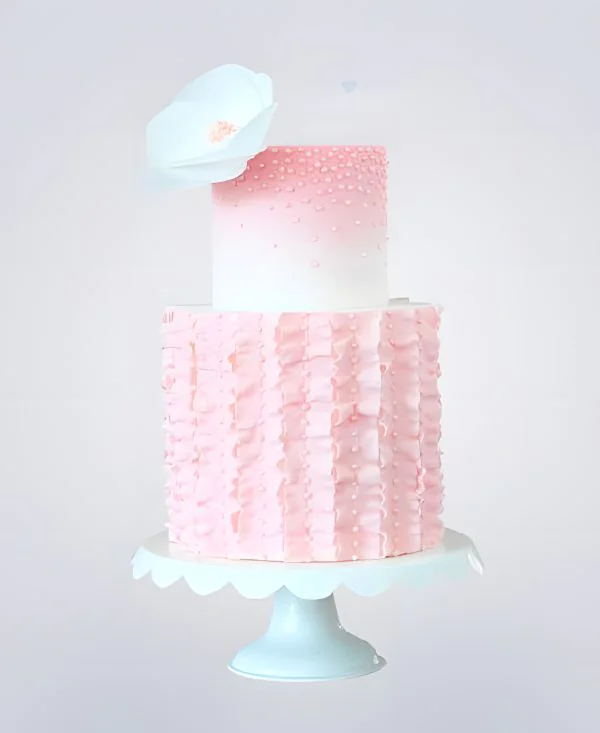 Двухъярусный розовый торт с бусинами и белым цветком Фото