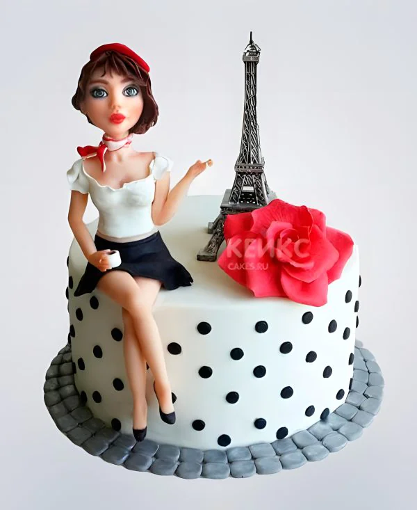 Прекрасный торт во французском стиле с фигуркой девушки Прекрасный торт во французском стиле с фигуркой девушки Фото