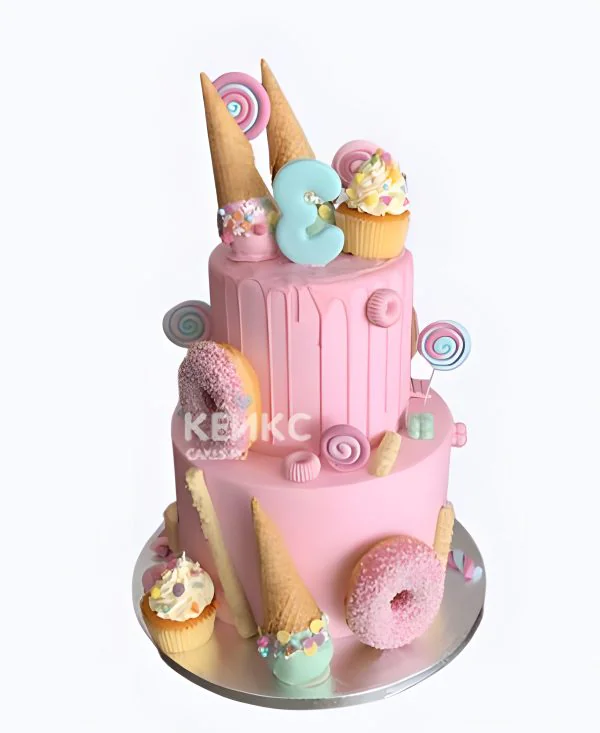 Двухъярусный розовый торт на 3 года девочке со сладостями Фото