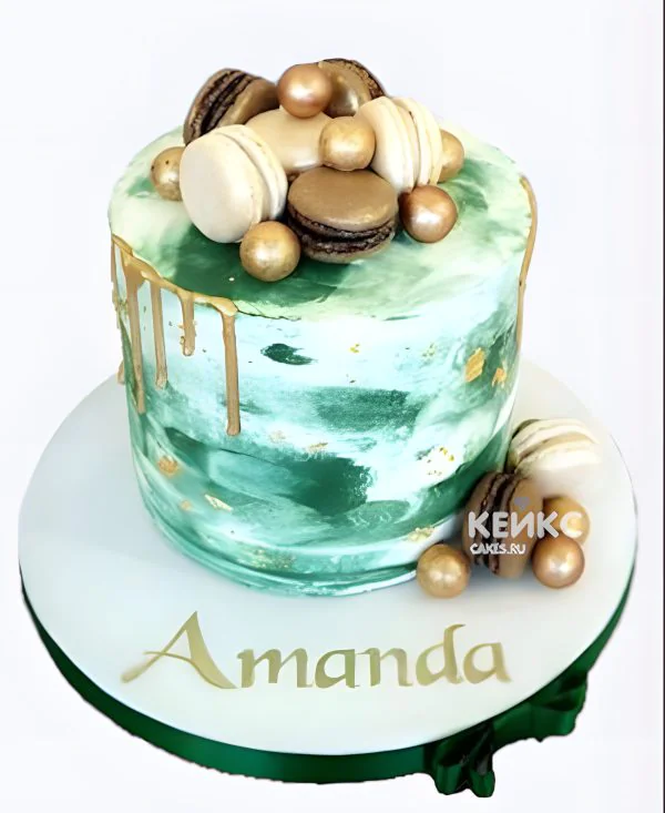 Пастельный зеленый торт с макарунс и золотыми шариками Пастельный зеленый торт с макарунс и золотыми шариками Фото
