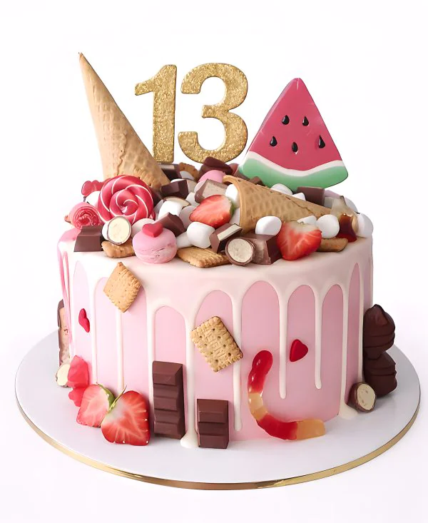 Детский торт с разными сладостями и долькой арбуза Фото