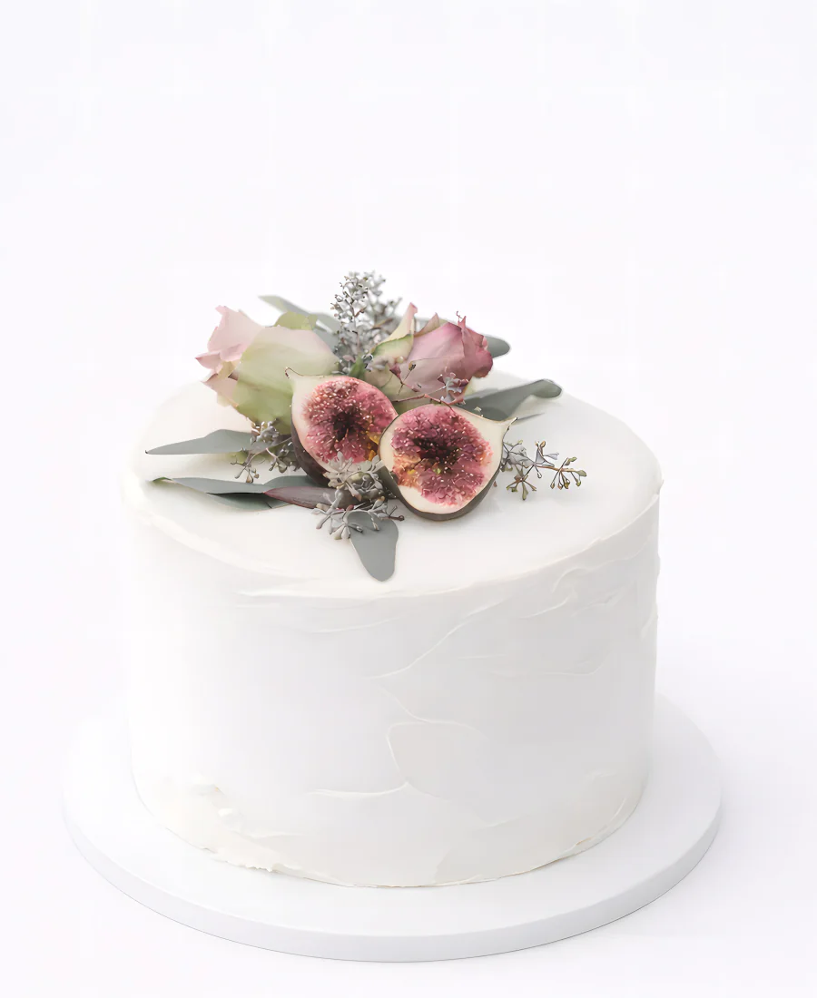 Белый торт украшенный цветами и инжиром Фото