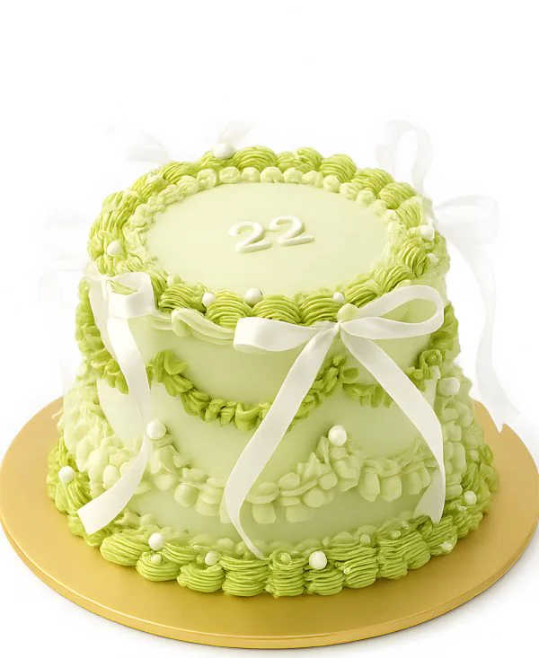 Зеленый торт с белыми бантиками Фото